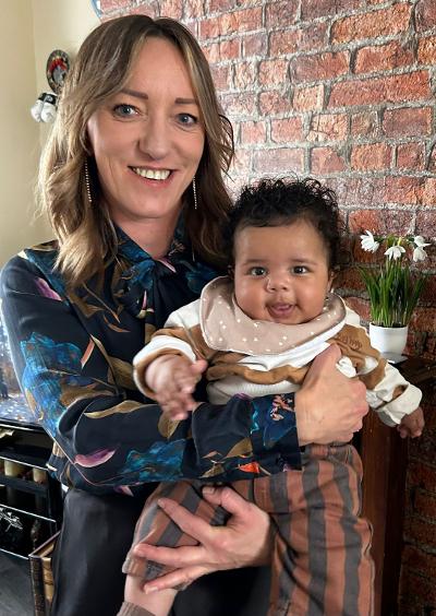 Tatiana holding happy baby after baby massage